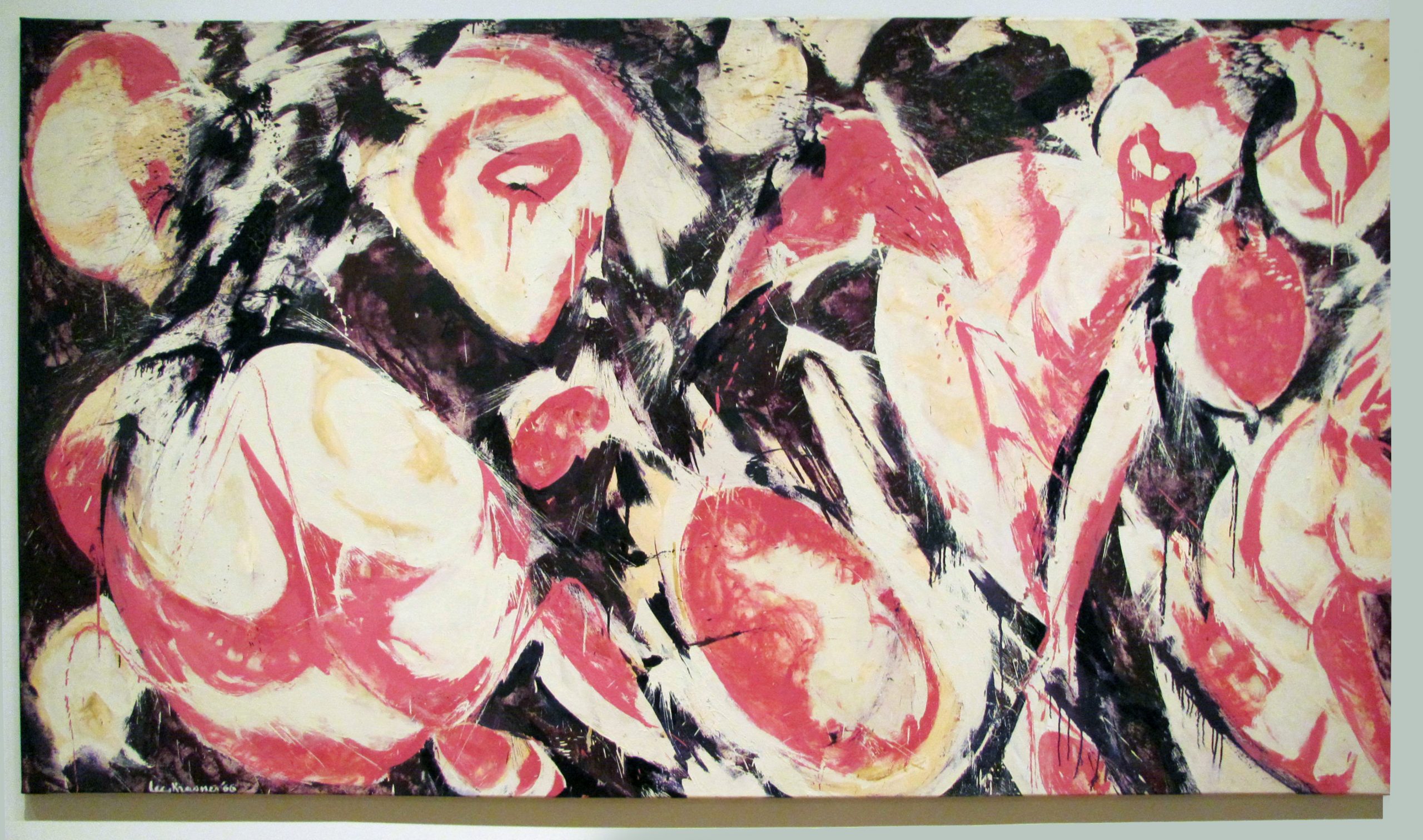 Abstract painting with roughly circular or oval shapes of red and white and black paint in between them.