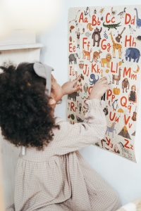 Little girl looking at ABC poster