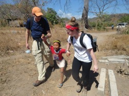 A picture of Kate, another student, and a young child