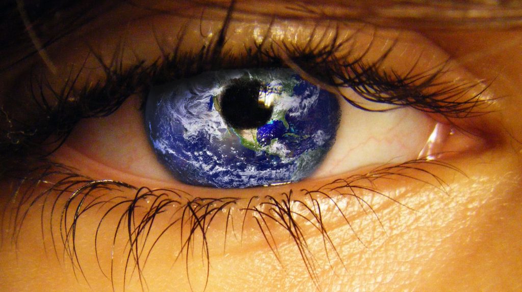 Human eye with world globe showing as the iris.